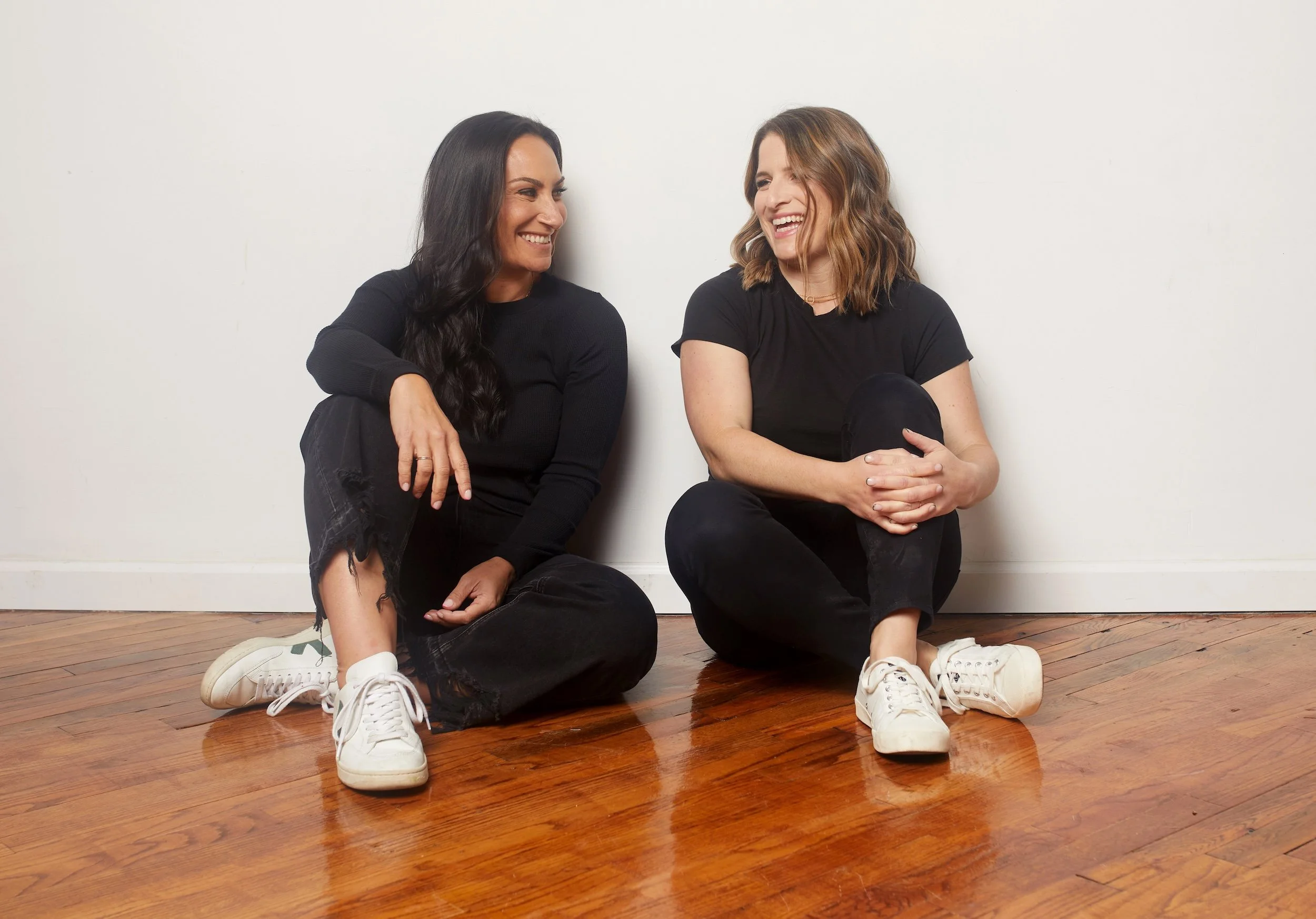 Jenna and Stacy seated on the floor